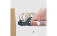 Dyspenser do taśmy pakowej Harmadon PushFlap 50 mm w użyciu z ergonomicznym uchwytem i ostrzem do szybkiego zaklejania kartonów podczas pakowania i przygotowania przesyłek